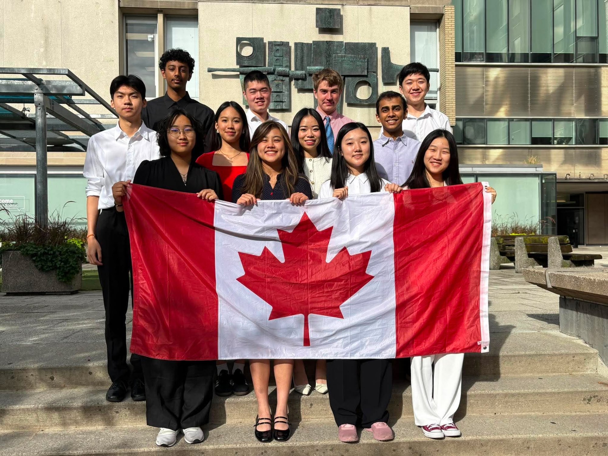 The 2026-2027 Team Canada debate team holding the Canadian flag at their training camp at the University of Toronto